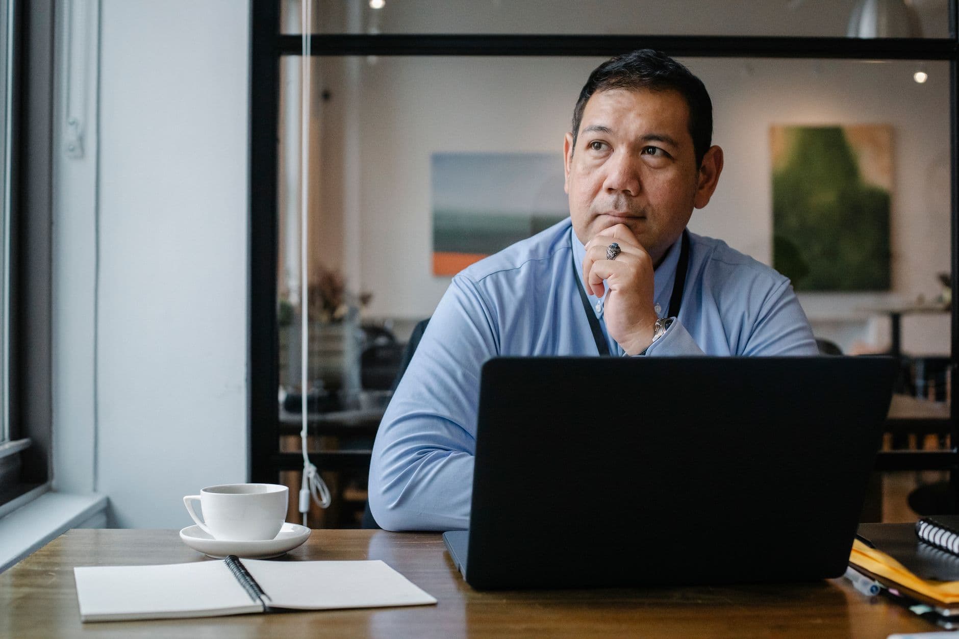 An executive in a moment of reflection at their desk
