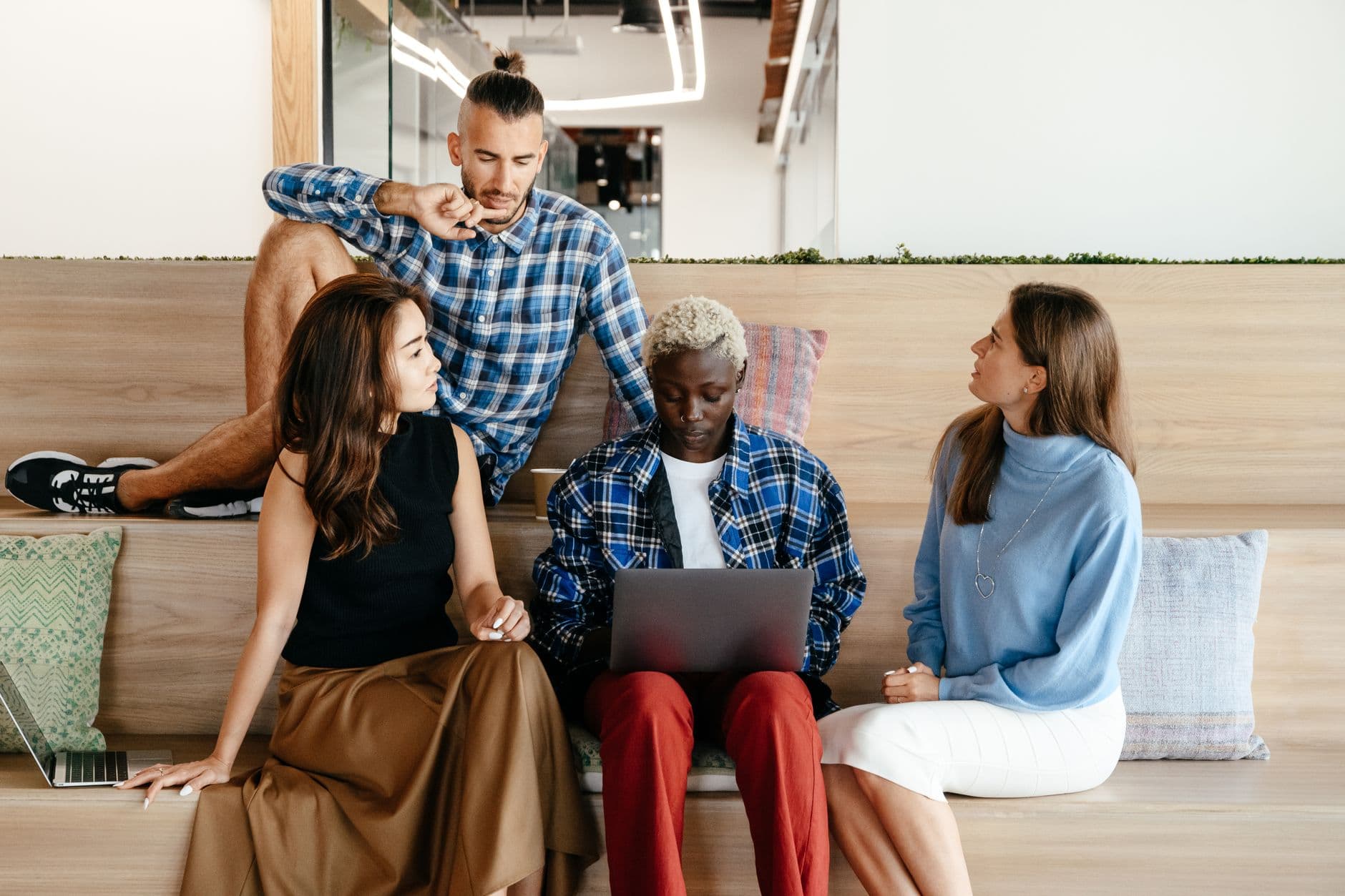 Colleagues collaborating around a shared workspace